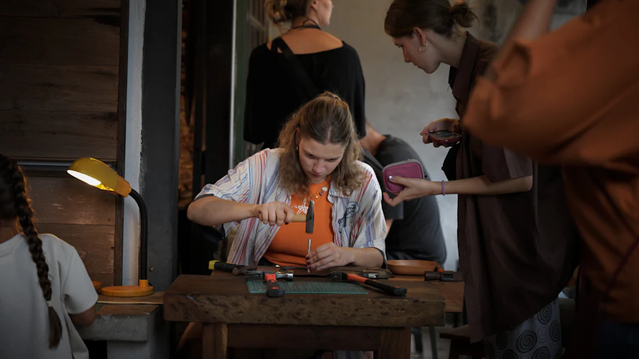 Craftsperson hand-stitching leather at a workbench