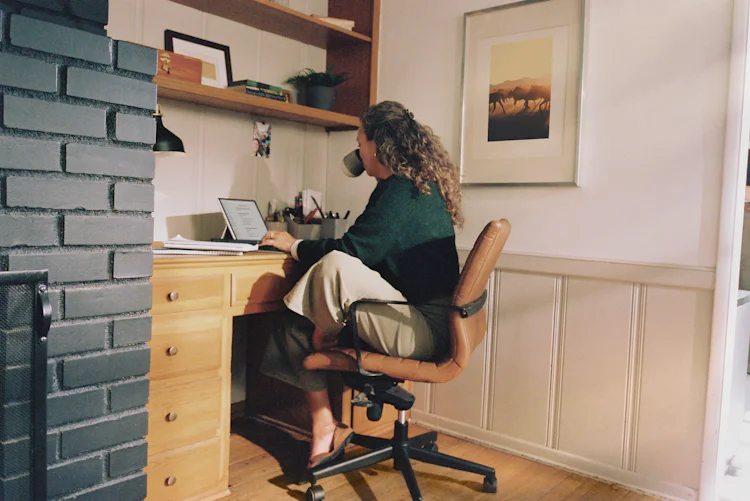 Business website for a small service business: owner working at a desk with coffee